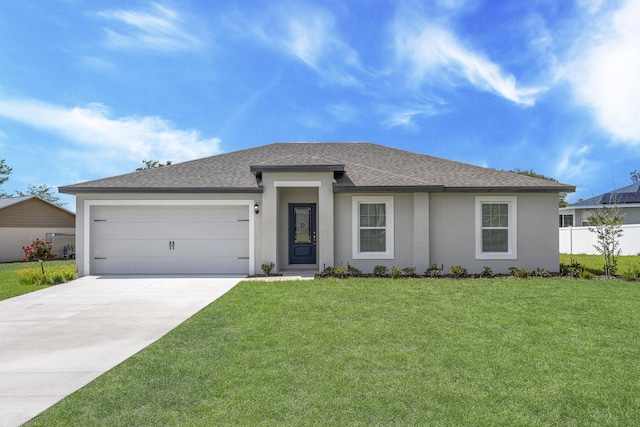 view of front of home with a garage and a front lawn