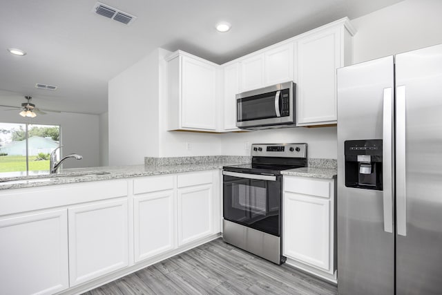 kitchen with white cabinetry, appliances with stainless steel finishes, and sink