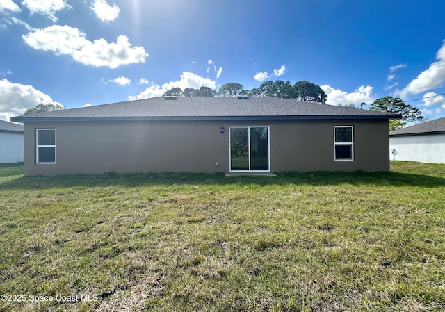 back of house with a lawn