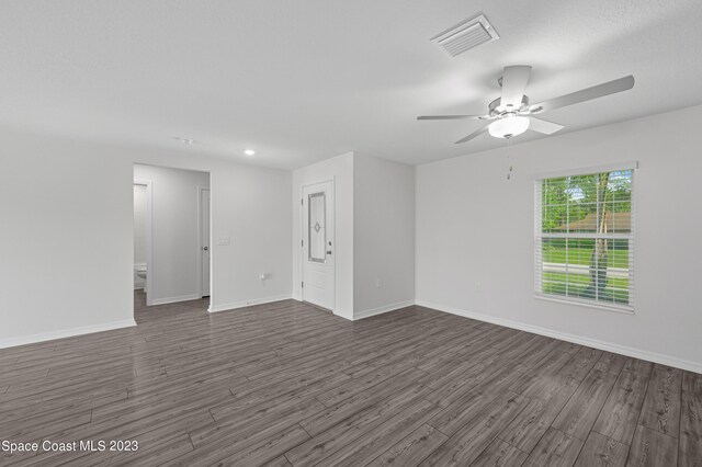 unfurnished room featuring ceiling fan and dark hardwood / wood-style flooring