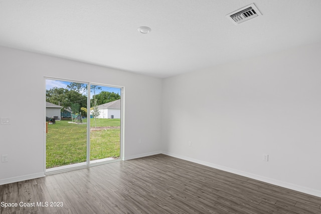 spare room featuring dark wood-type flooring