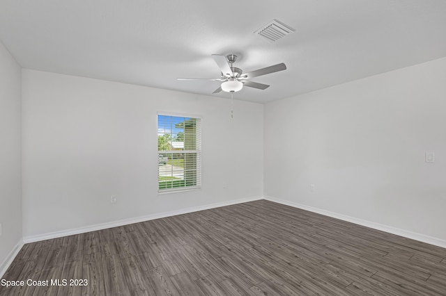 empty room with dark wood-type flooring and ceiling fan