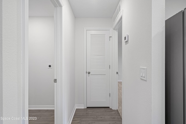 corridor with light hardwood / wood-style floors