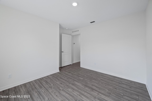 unfurnished room with hardwood / wood-style flooring