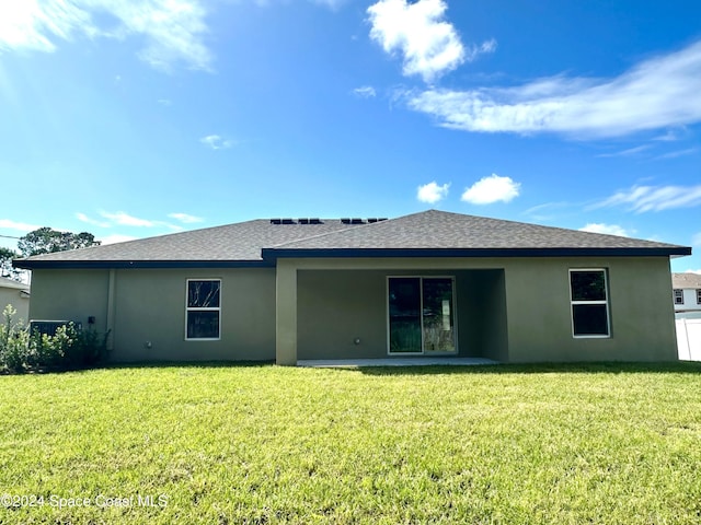 rear view of property with a yard