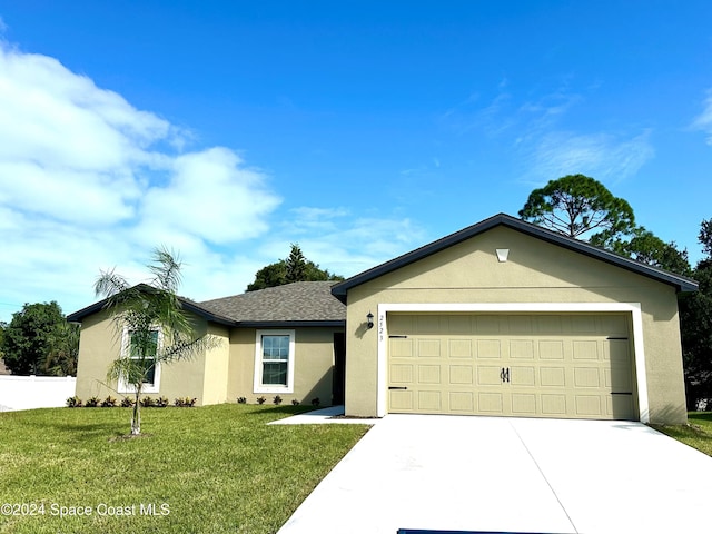 ranch-style house with a garage and a front lawn