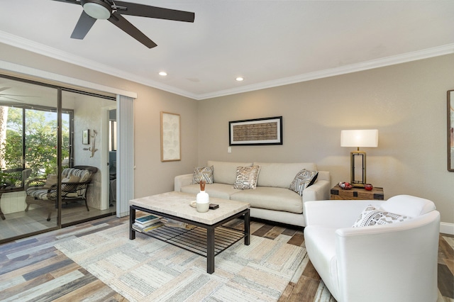 living room with ceiling fan, wood-type flooring, and ornamental molding