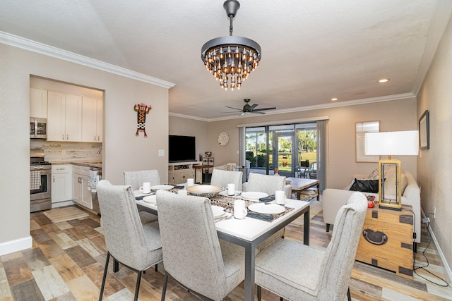 dining room featuring light hardwood / wood-style flooring, ceiling fan with notable chandelier, and ornamental molding