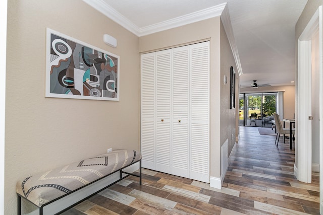 hallway with crown molding and hardwood / wood-style flooring