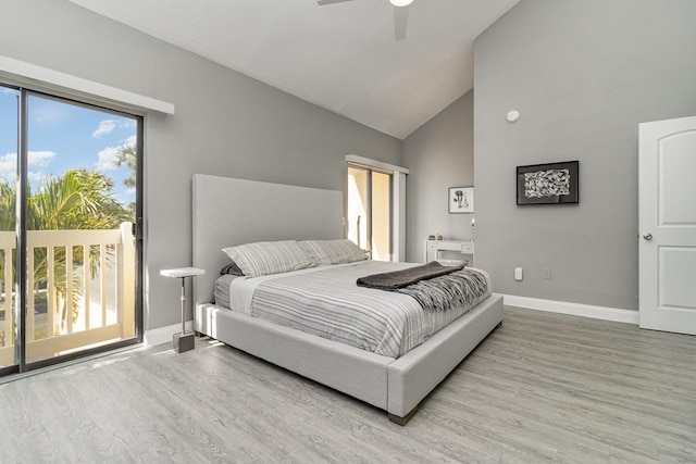 bedroom with hardwood / wood-style flooring, ceiling fan, access to exterior, and high vaulted ceiling