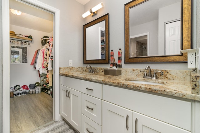 bathroom featuring vanity, hardwood / wood-style floors, and a textured ceiling