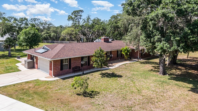 ranch-style home with a front yard and a garage