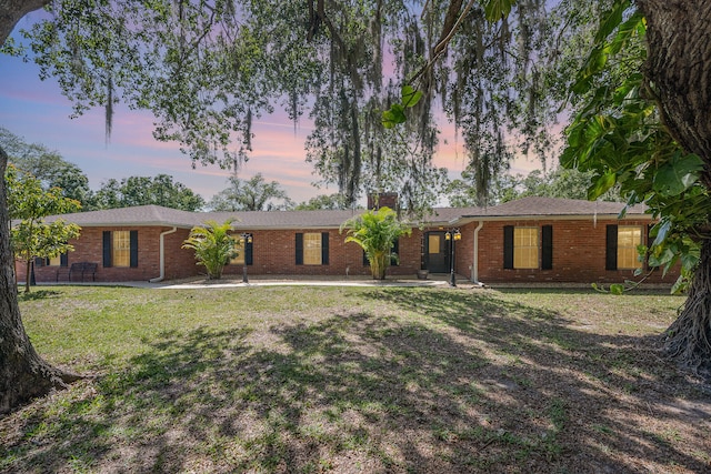 ranch-style house with a yard