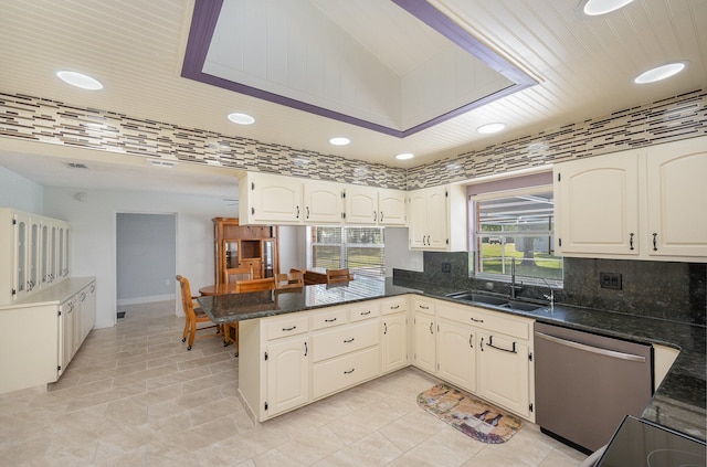 kitchen featuring dishwasher, sink, light tile floors, and kitchen peninsula