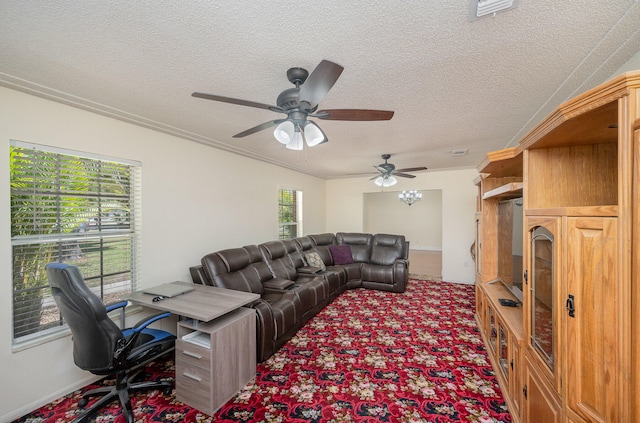 carpeted living room with a wealth of natural light, ceiling fan, a textured ceiling, and crown molding