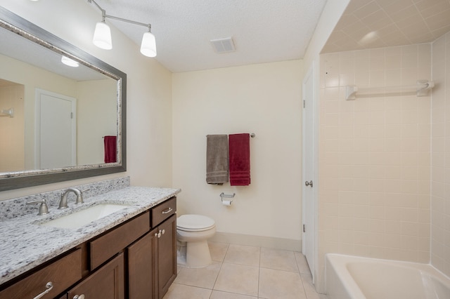 full bathroom featuring oversized vanity, toilet, tiled shower / bath combo, tile floors, and a textured ceiling