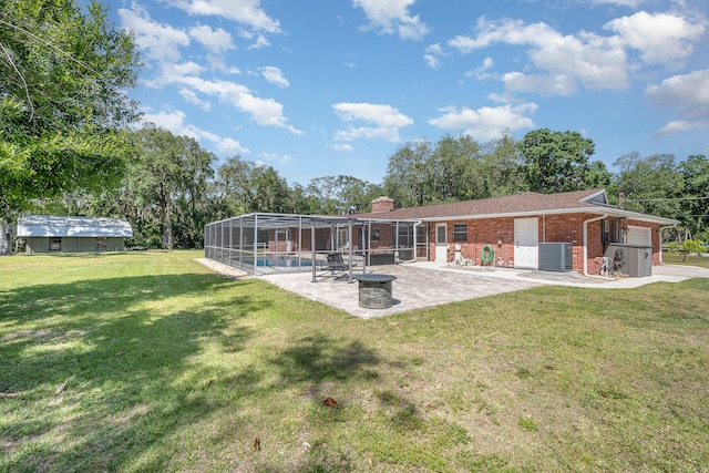 back of house featuring a patio area, a swimming pool, and a lawn