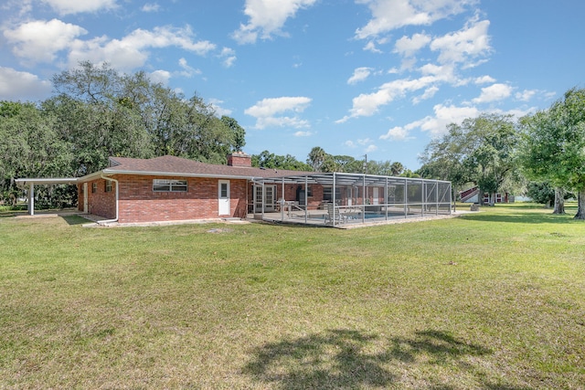 back of house featuring a yard, a swimming pool, and a patio