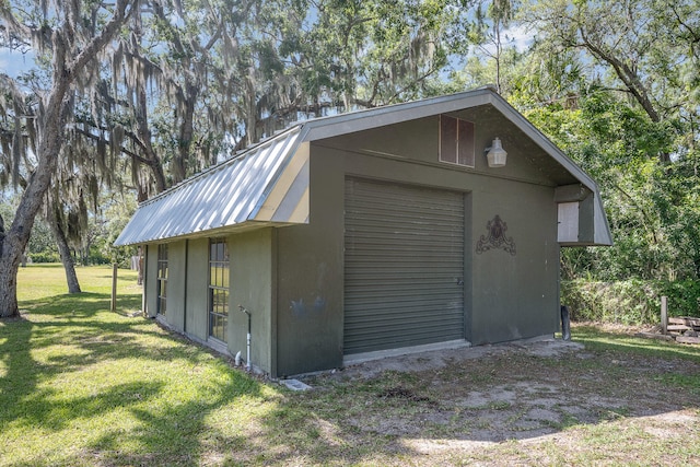 garage featuring a lawn