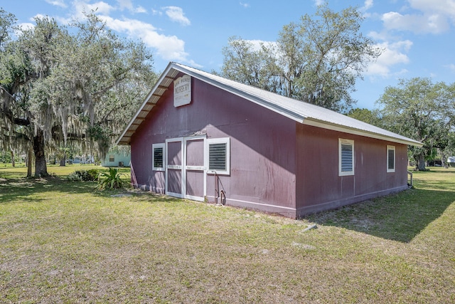 view of side of home with a yard