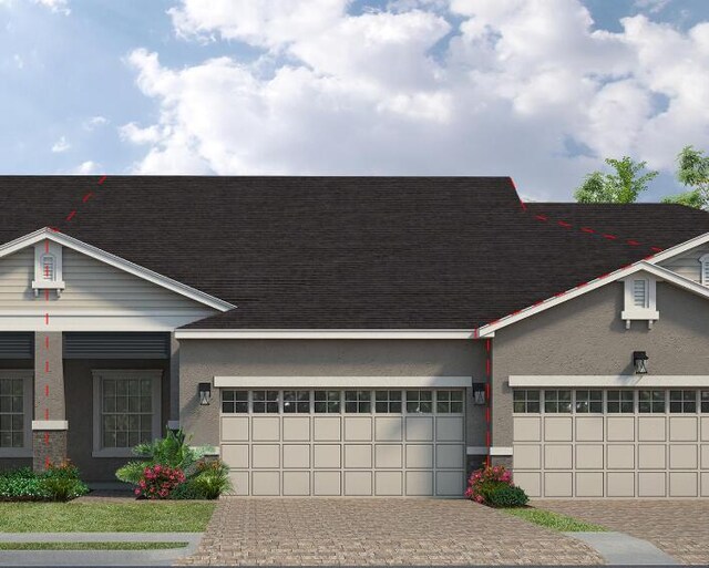 7707 Cache Creek Ln, Melbourne, FL 32940 - view of front facade featuring a garage, roof with shingles, decorative driveway, and stucco siding