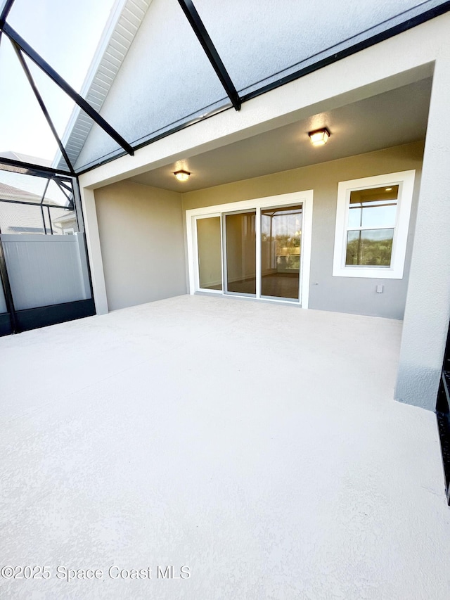 unfurnished sunroom featuring a skylight