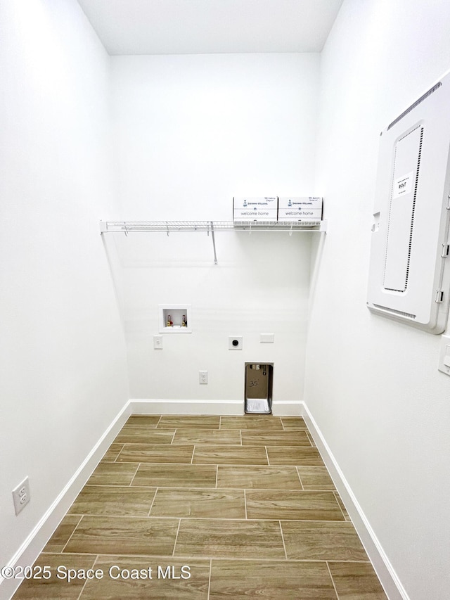 washroom with laundry area, wood finish floors, washer hookup, baseboards, and electric dryer hookup