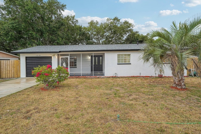 ranch-style home featuring a garage and a front lawn