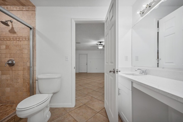 bathroom featuring tile patterned floors, a shower with shower door, vanity, ceiling fan, and toilet