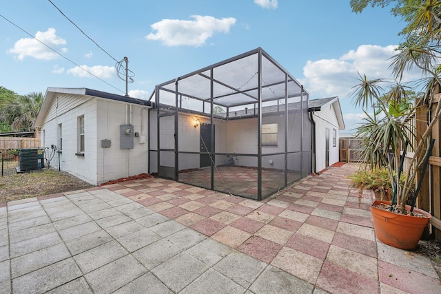 exterior space with glass enclosure and central AC unit