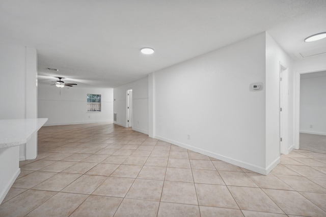 unfurnished living room featuring ceiling fan and light tile patterned floors