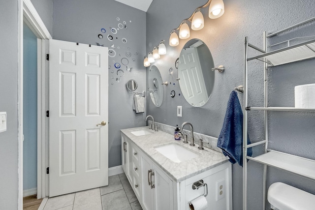 bathroom with tile patterned floors, vanity, and toilet