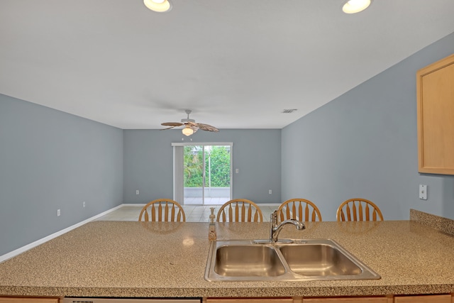 kitchen with light colored carpet, sink, light brown cabinetry, and ceiling fan