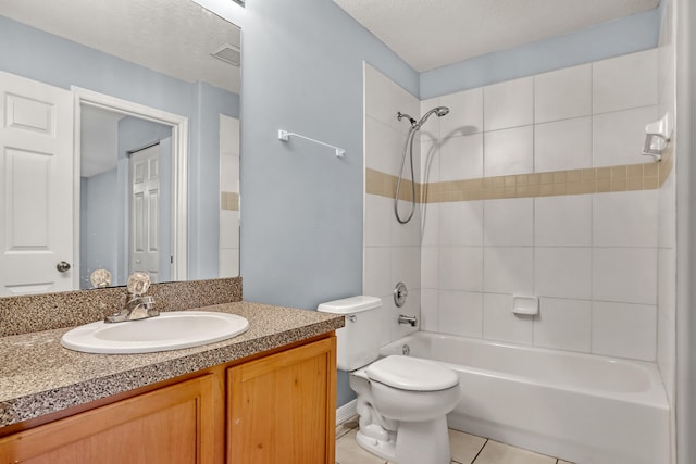 full bathroom with tile flooring, tiled shower / bath combo, a textured ceiling, toilet, and vanity