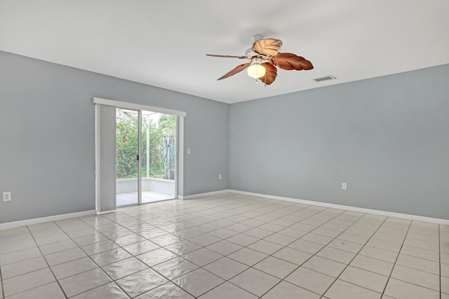 empty room featuring light tile flooring and ceiling fan