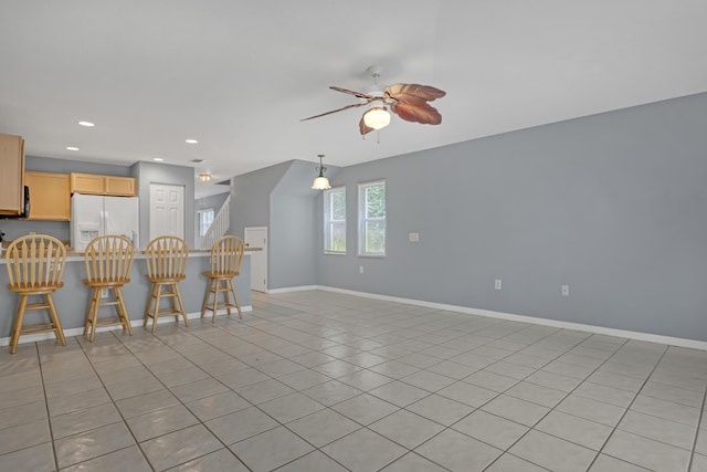 interior space with ceiling fan