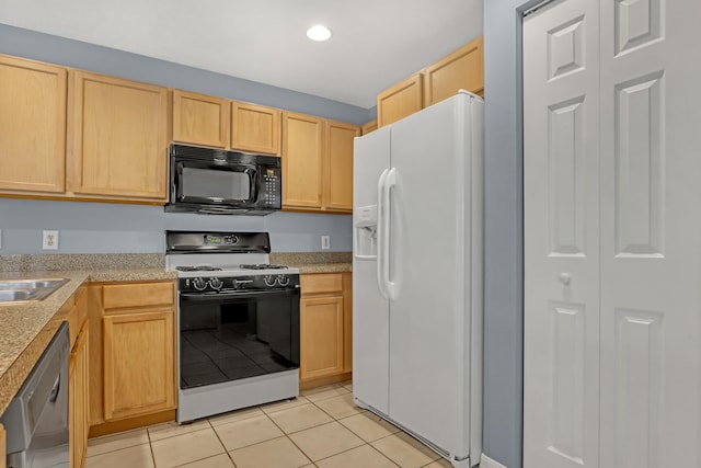 kitchen featuring light brown cabinets, white appliances, and light tile floors