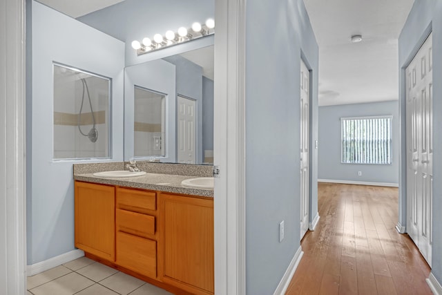 bathroom featuring double sink, tile floors, and large vanity