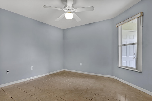 tiled empty room with ceiling fan