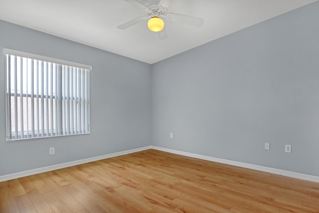 empty room with ceiling fan and light hardwood / wood-style flooring