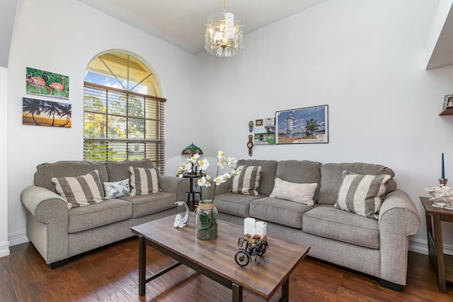 living room with dark hardwood / wood-style flooring and a notable chandelier