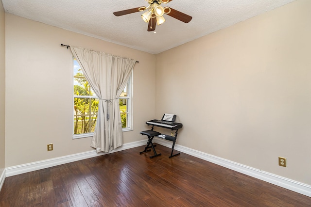 unfurnished room featuring ceiling fan, dark hardwood / wood-style flooring, and a textured ceiling