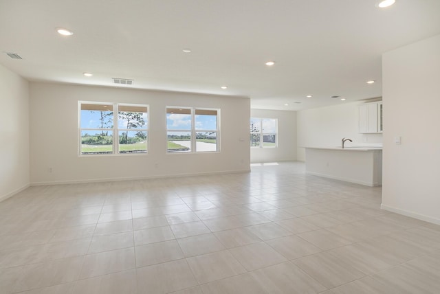 tiled spare room featuring sink