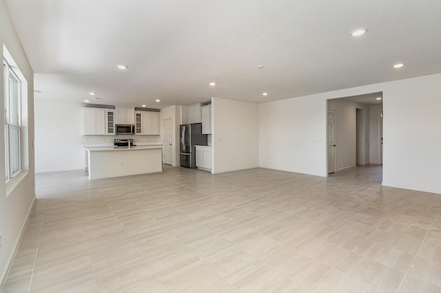 unfurnished living room with light tile patterned flooring