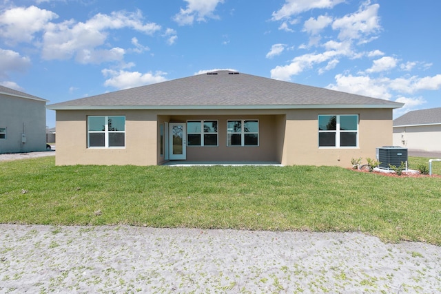 back of house with a lawn and central AC