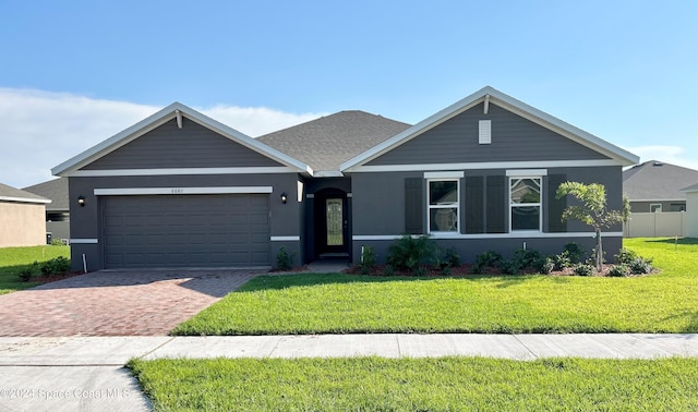 ranch-style home with a front yard and a garage