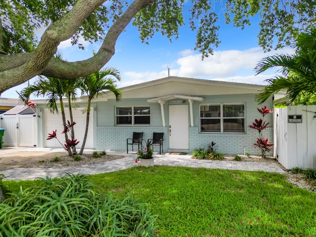 280 Monroe Ave, Cape Canaveral, FL 32920 - view of front of house featuring brick siding, a gate, a garage, and a porch