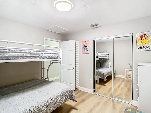 280 Monroe Ave, Cape Canaveral, FL 32920 - bedroom featuring attic access, a closet, light wood-type flooring, and baseboards
