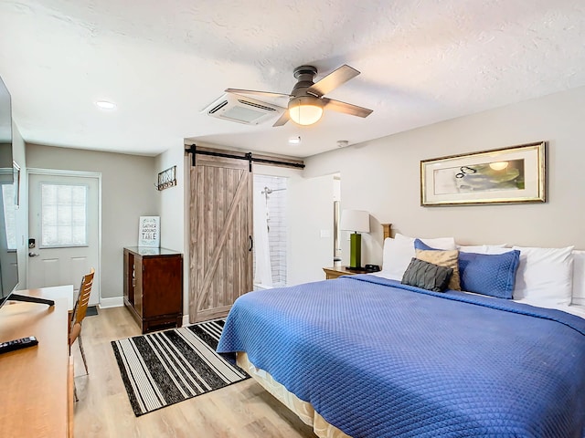 280 Monroe Ave, Cape Canaveral, FL 32920 - bedroom featuring a barn door, light wood-style flooring, ceiling fan, and baseboards