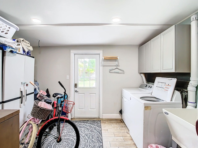 280 Monroe Ave, Cape Canaveral, FL 32920 - washroom featuring cabinet space, independent washer and dryer, recessed lighting, and wood tiled floors